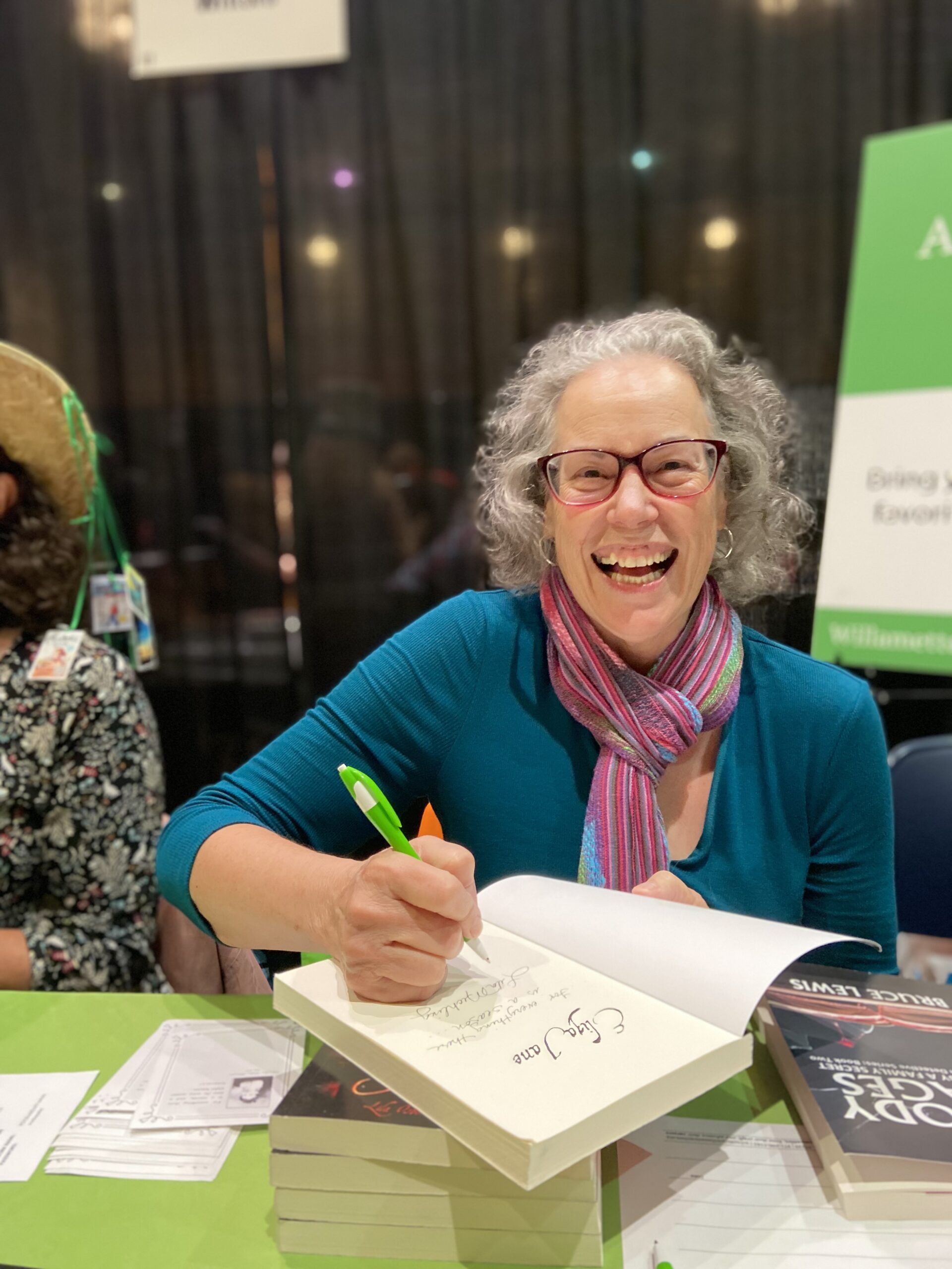 Member smiling at Portland Book Festival by Kate Ristau