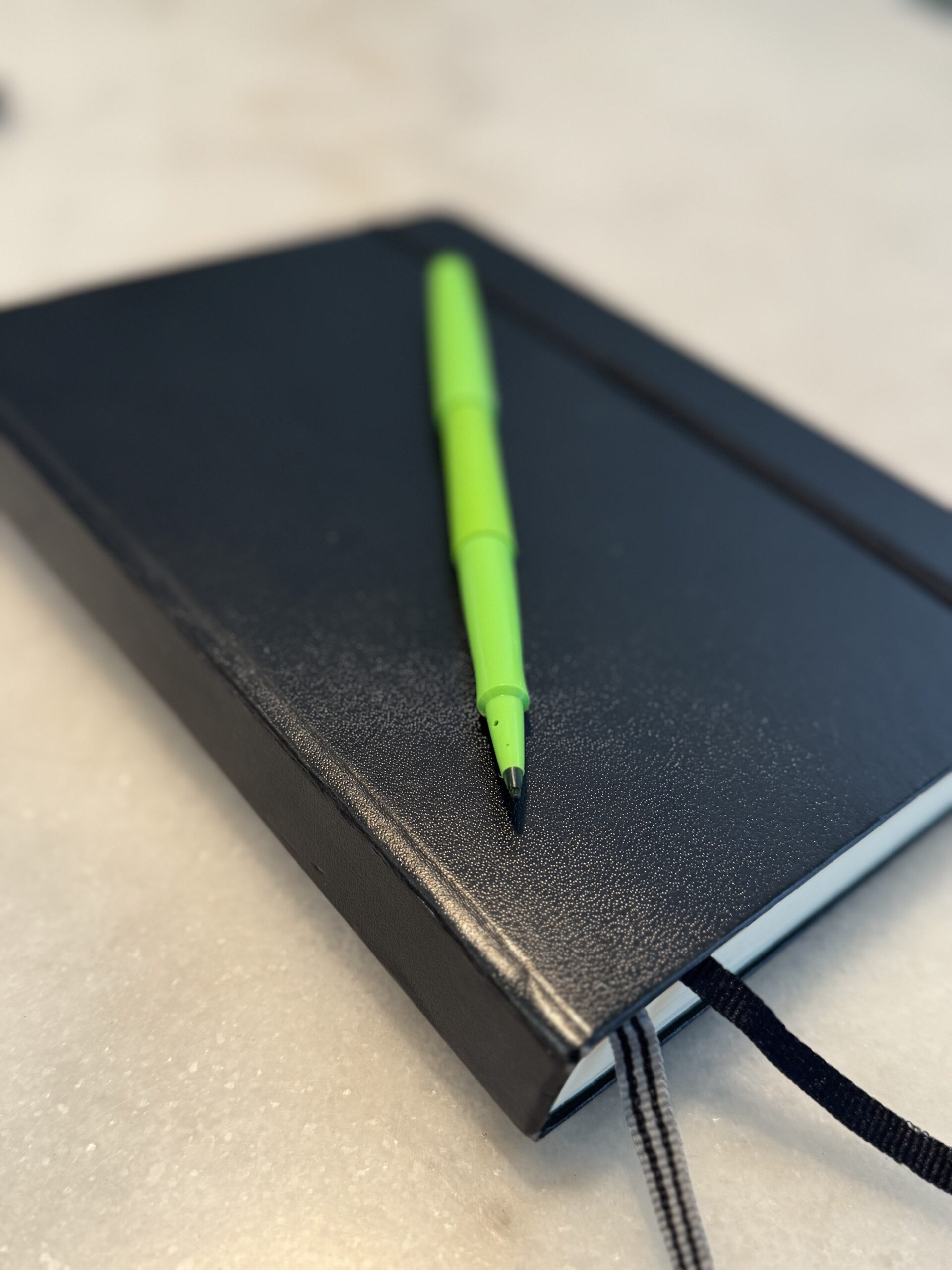 Journal with a green pen, photo by Kate Ristau